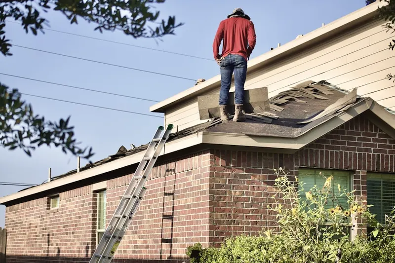 Professional roofer working on a residential roof in Norton